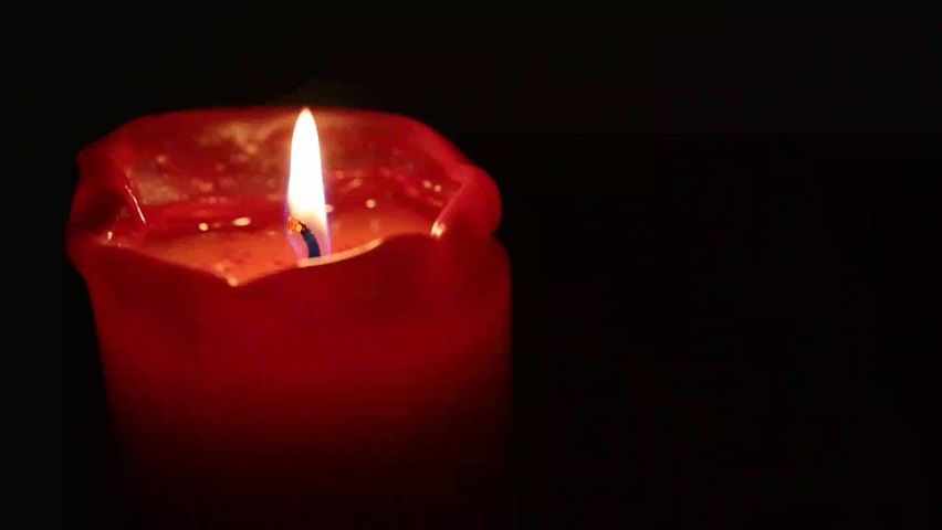 Video of a red candle with burning flame