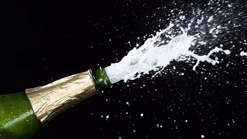 Video of a champagne bottle popping with the cork flying out