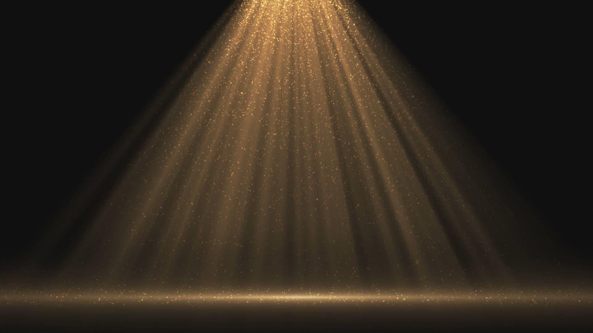 Video of a spotlight glittering with gold dust