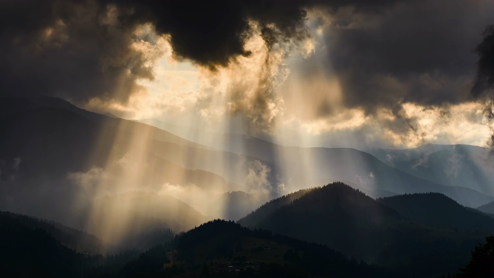 Video of mountains in the summer with sun and clouds