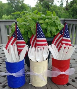 Three cans on a table in blue, red, white.